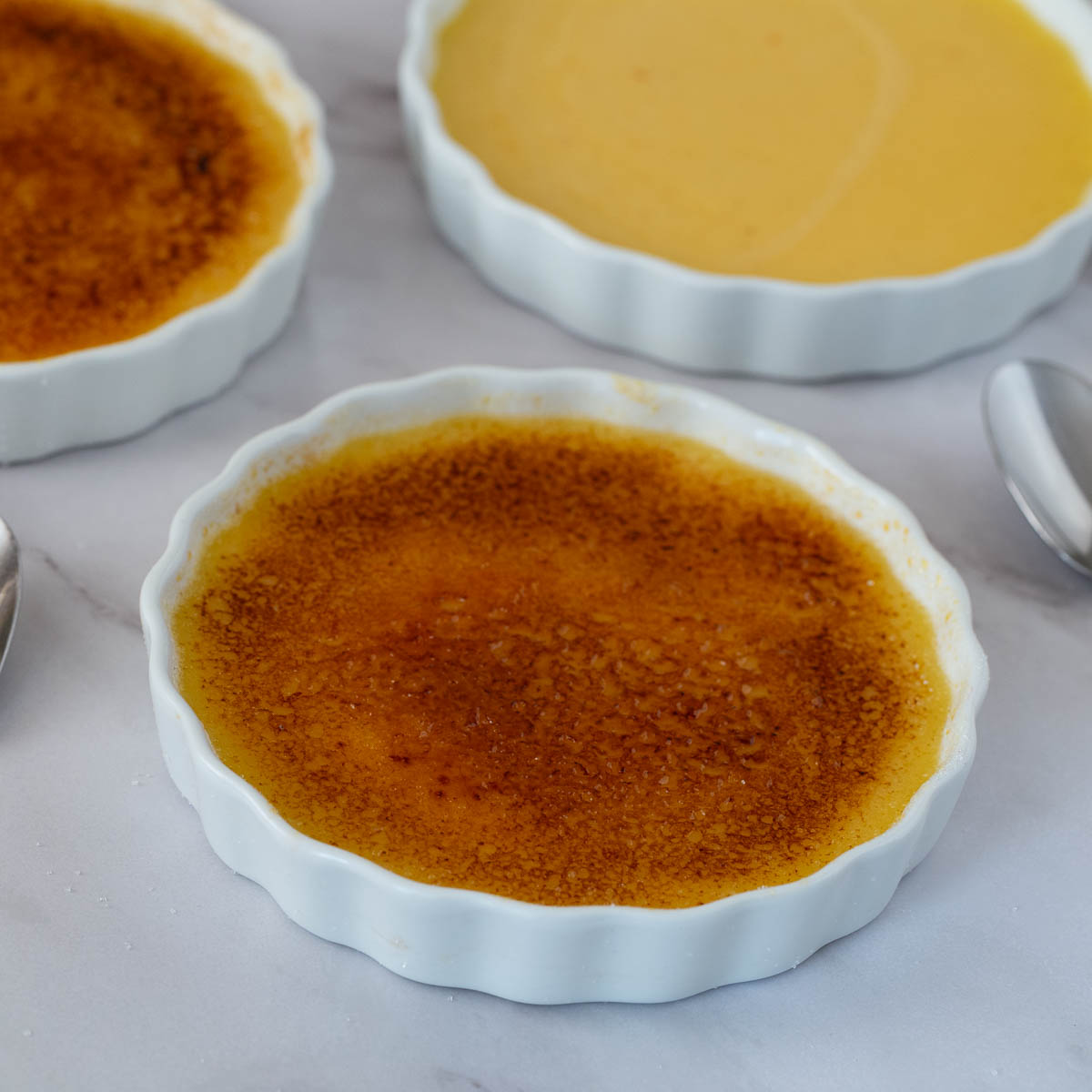 Three 6-oz ramekins with crème brûlée.