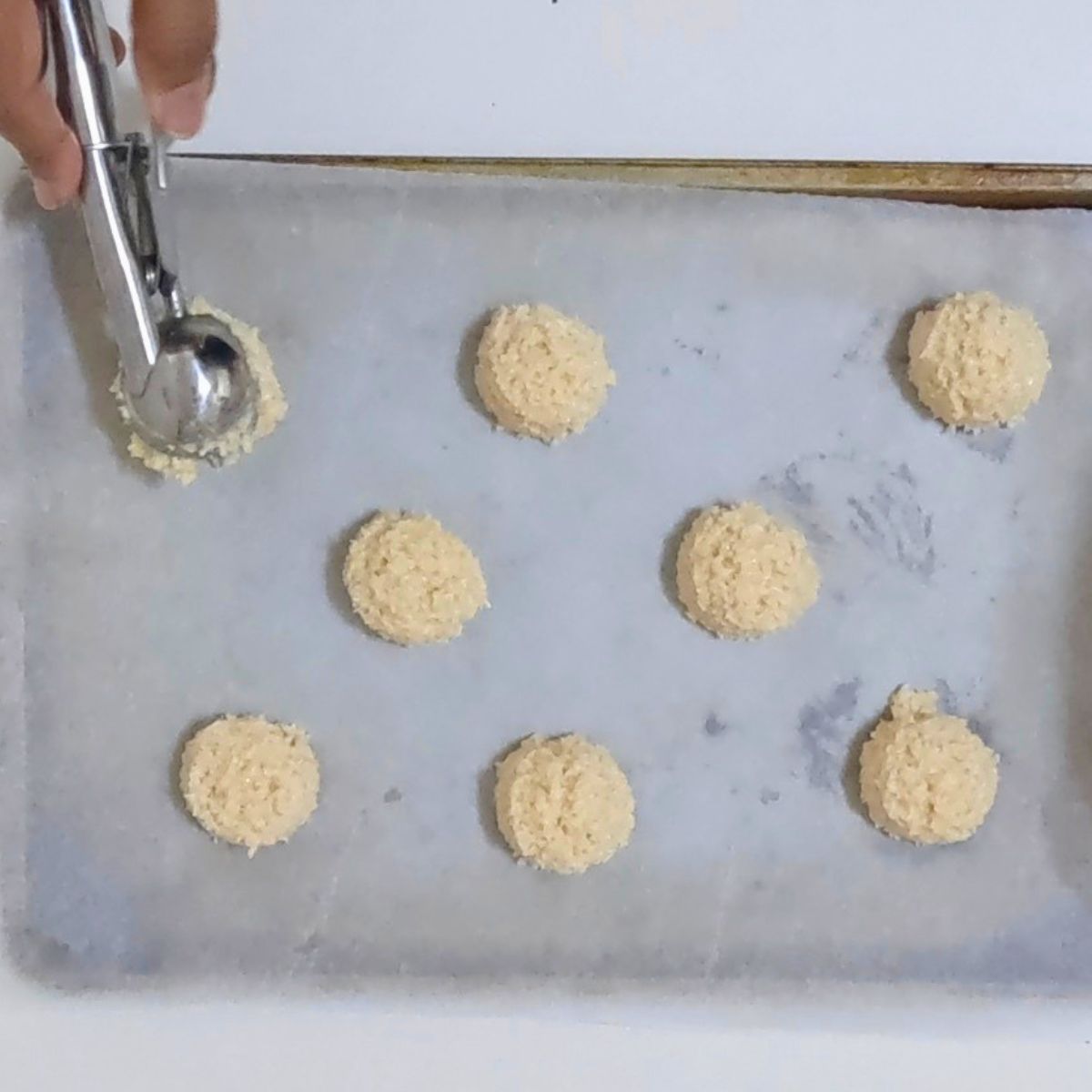 Scoop macaroons with a cookie scooper.
