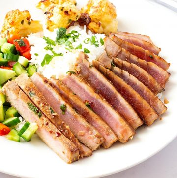 A plate with pan seared ahi tuna steak.