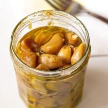 A mason jar with roasted garlic cloves.