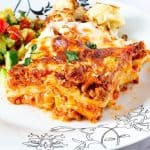 A slice of lasagna on a plate.