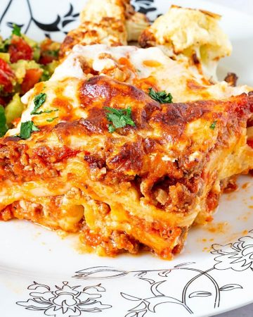 A slice of lasagna on a plate.