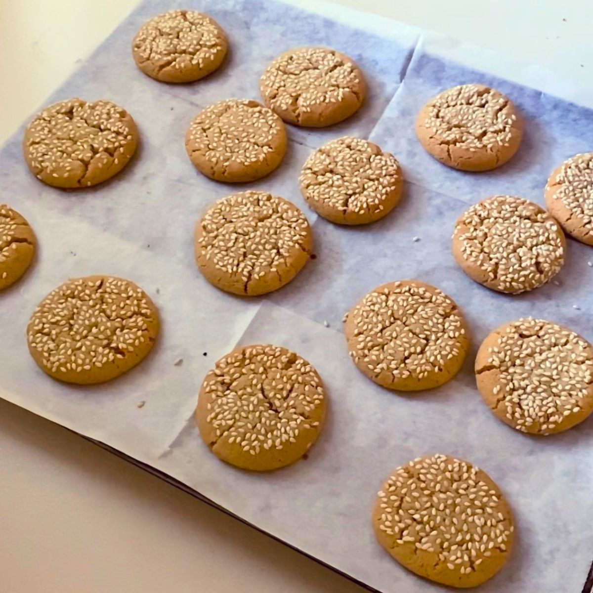Baking tray with fresh tahini cookies.