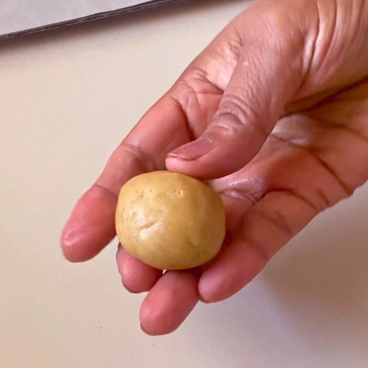 A sesame cookie dough ball for baking.