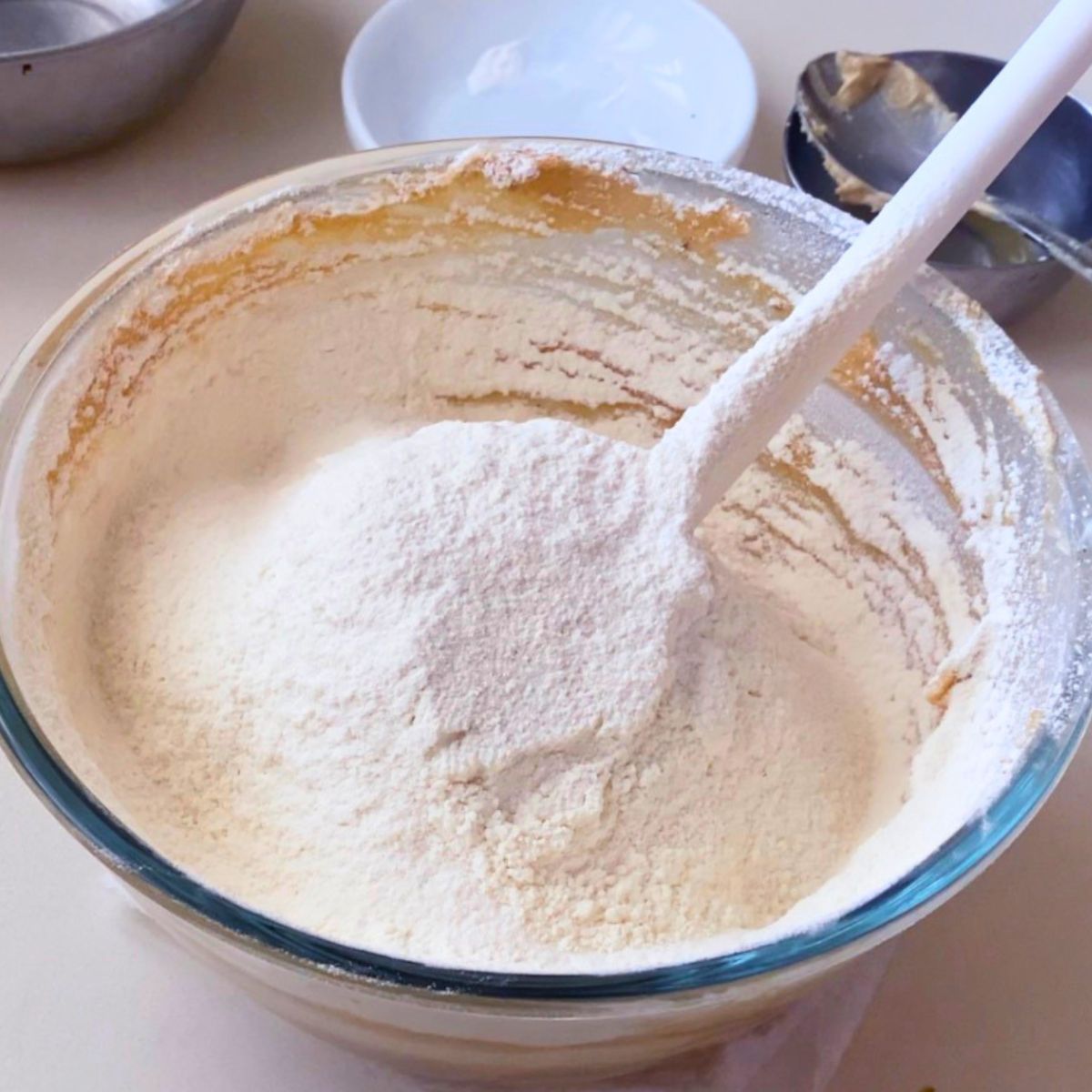 Adding flour to the sesame cookie dough.