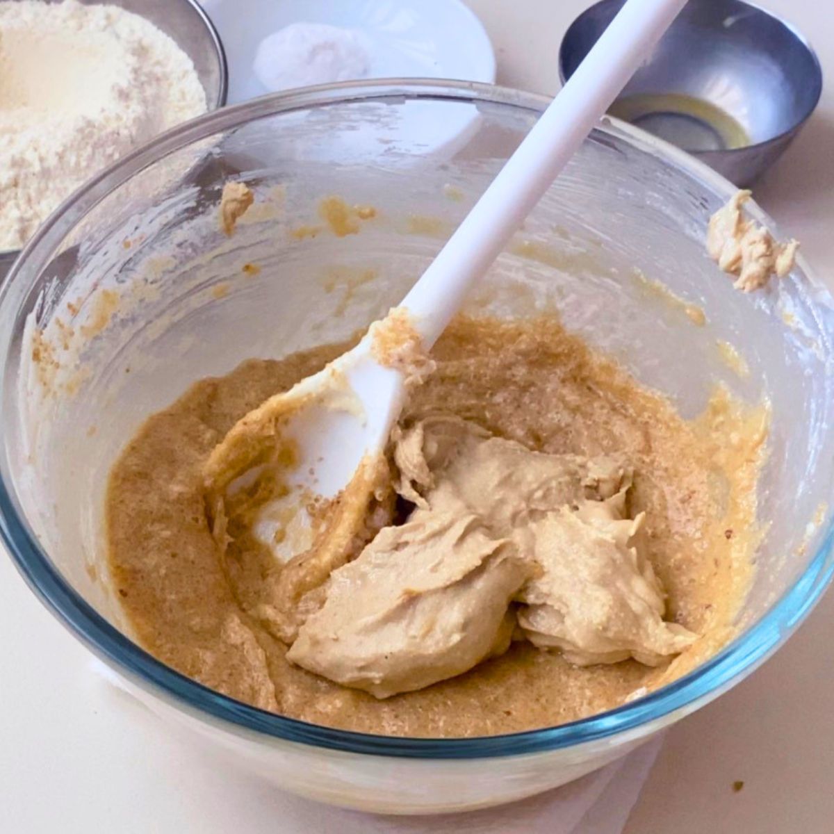 Adding sesame paste to the tahini cookie dough.