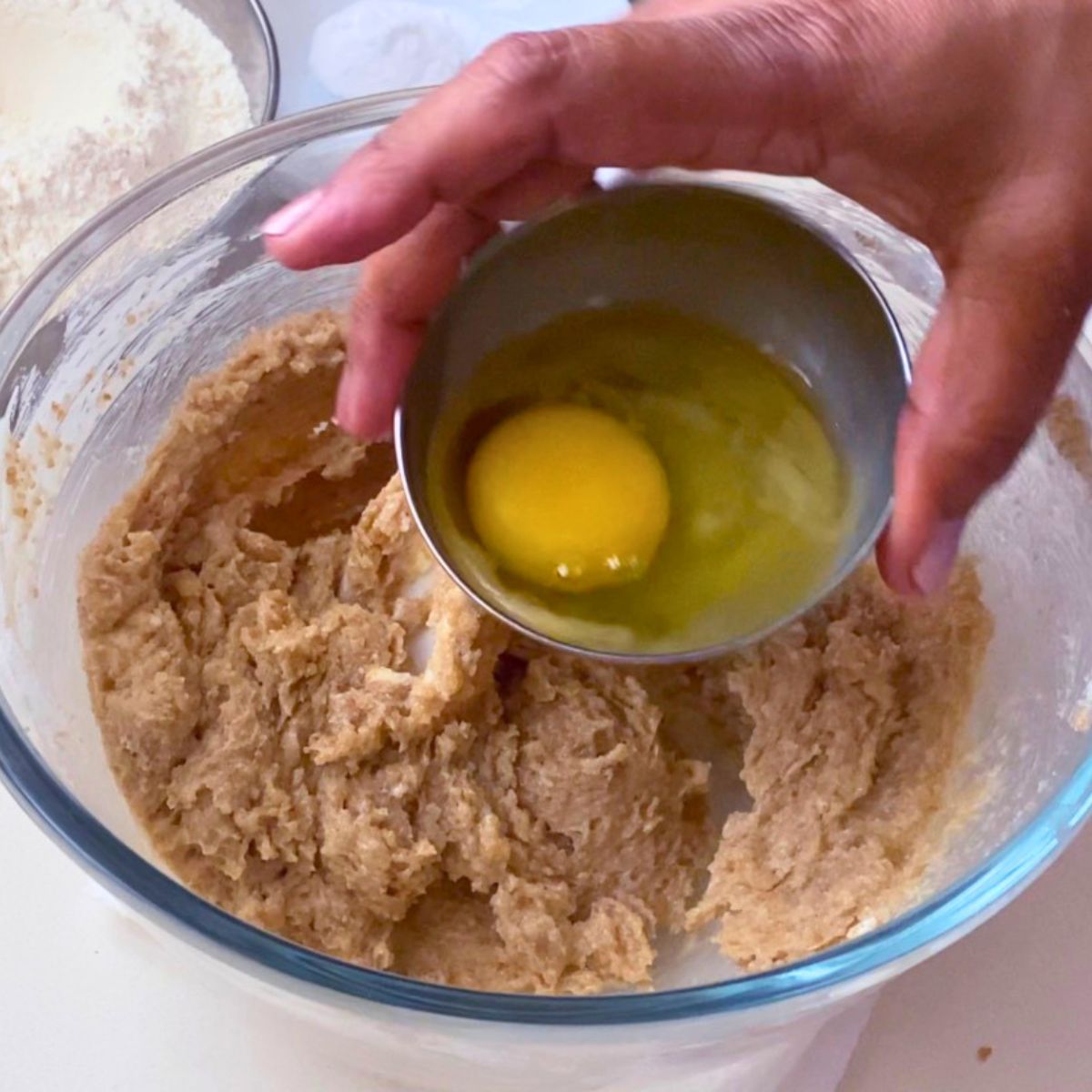 Adding egg and egg yolk to the tahini cookie dough