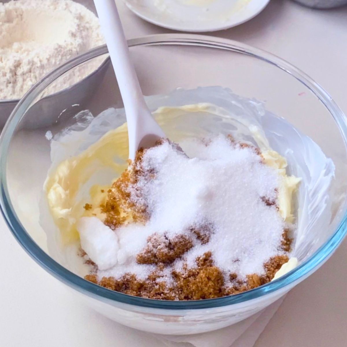 Creaming the butter with brown and white sugar.