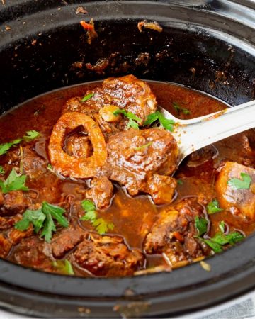 A slow cooker with veal shanks.
