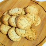 A stack of cookies on a wooden board.