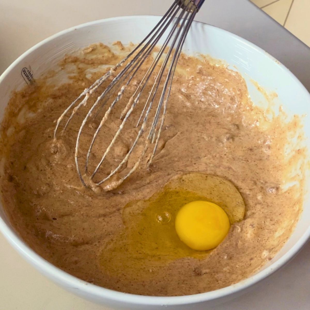Adding eggs to the cake batter.