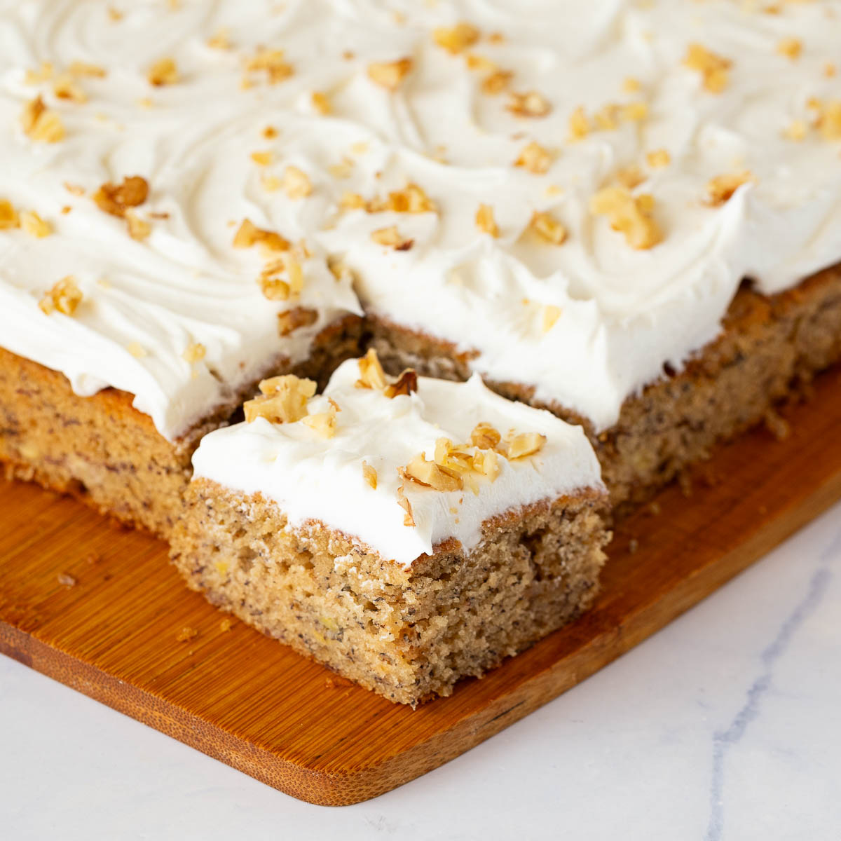 A frosted banana cake on the table.