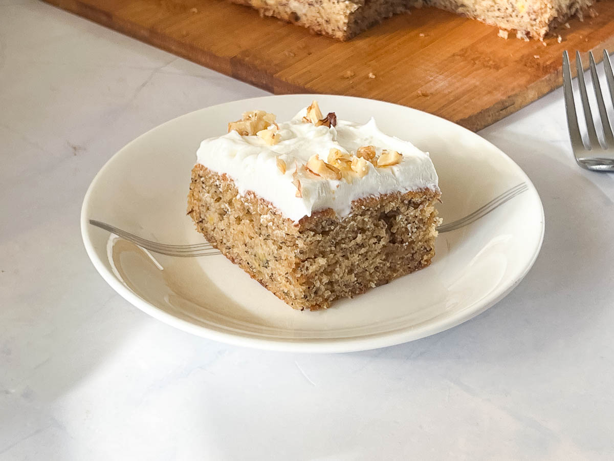 A frosted slice of cake on the saucer.