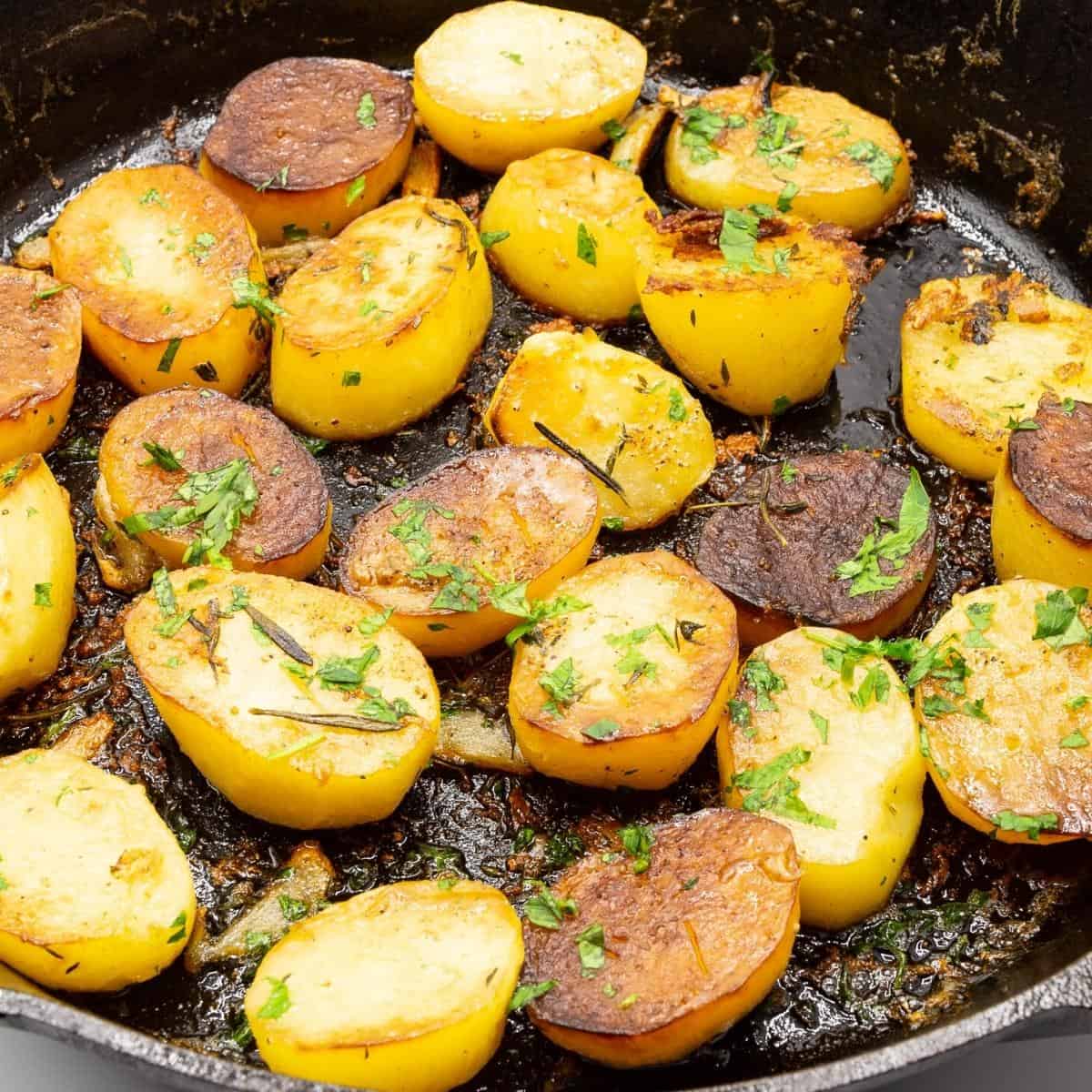 A skillet with cooking potatoes.