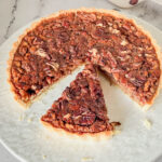 A slice of pecan tart on the table.