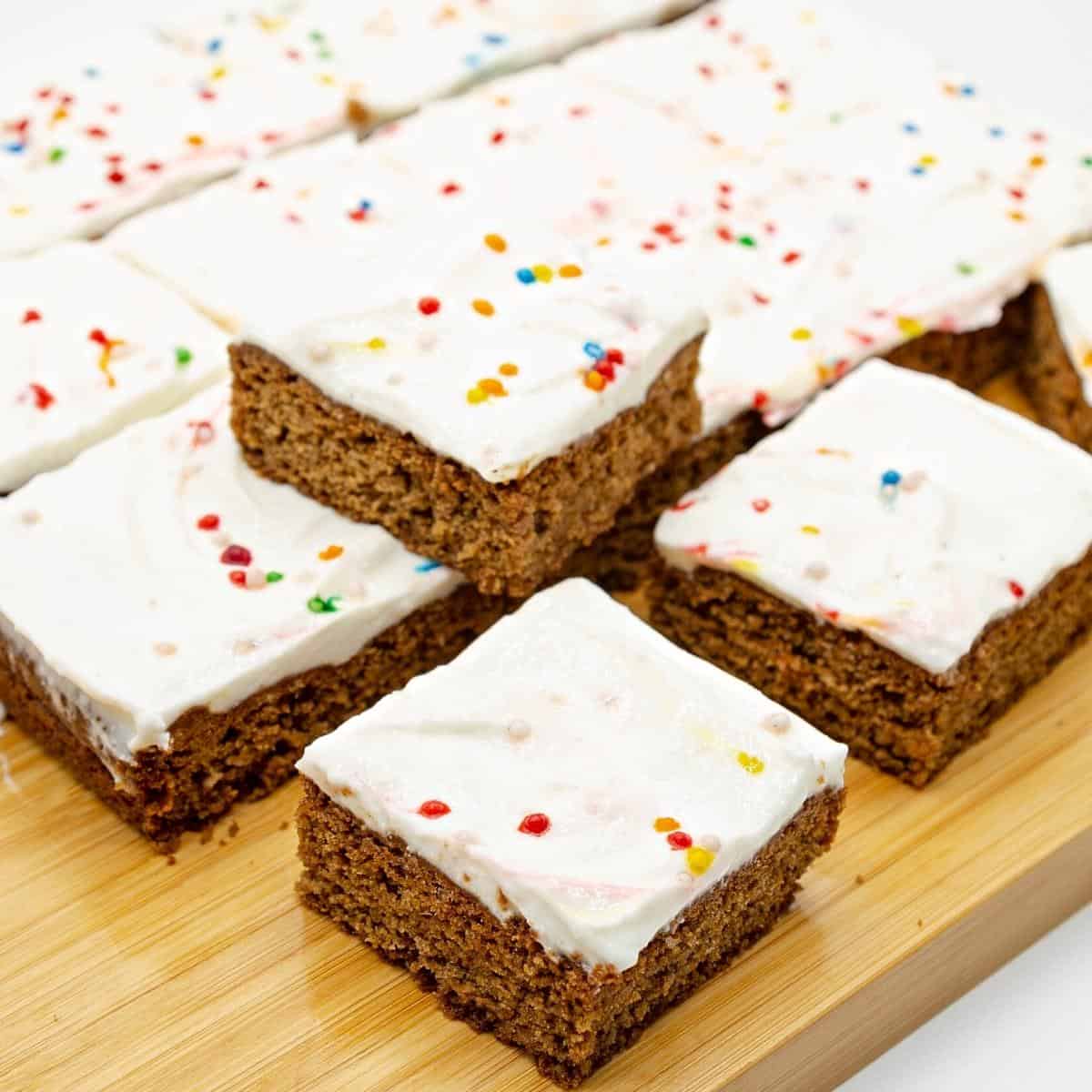 Gingerbread cookie bars on a wooden board.