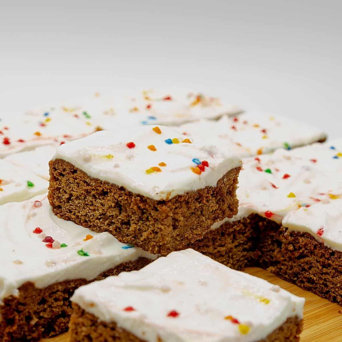 Stack of gingerbread cookie bars on a wooden board.