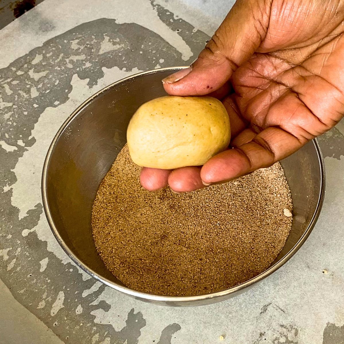 Rolling the dough in a oval shape.