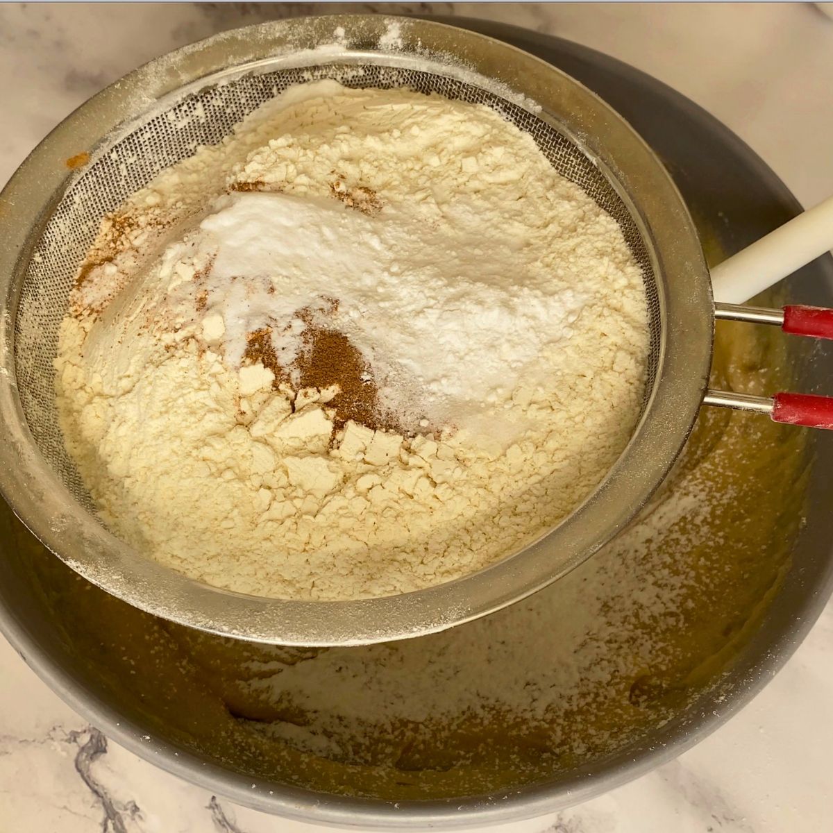 Adding flour to the cookie dough.