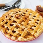 A lattice top apple pie in a pie pan.