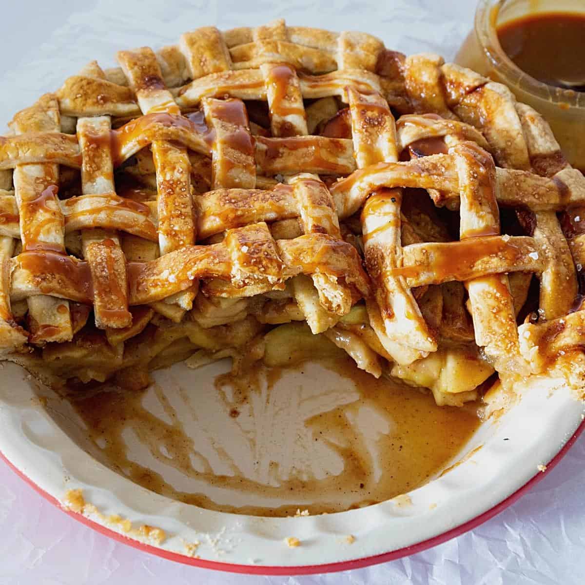 Half apple pie in a pie pan.
