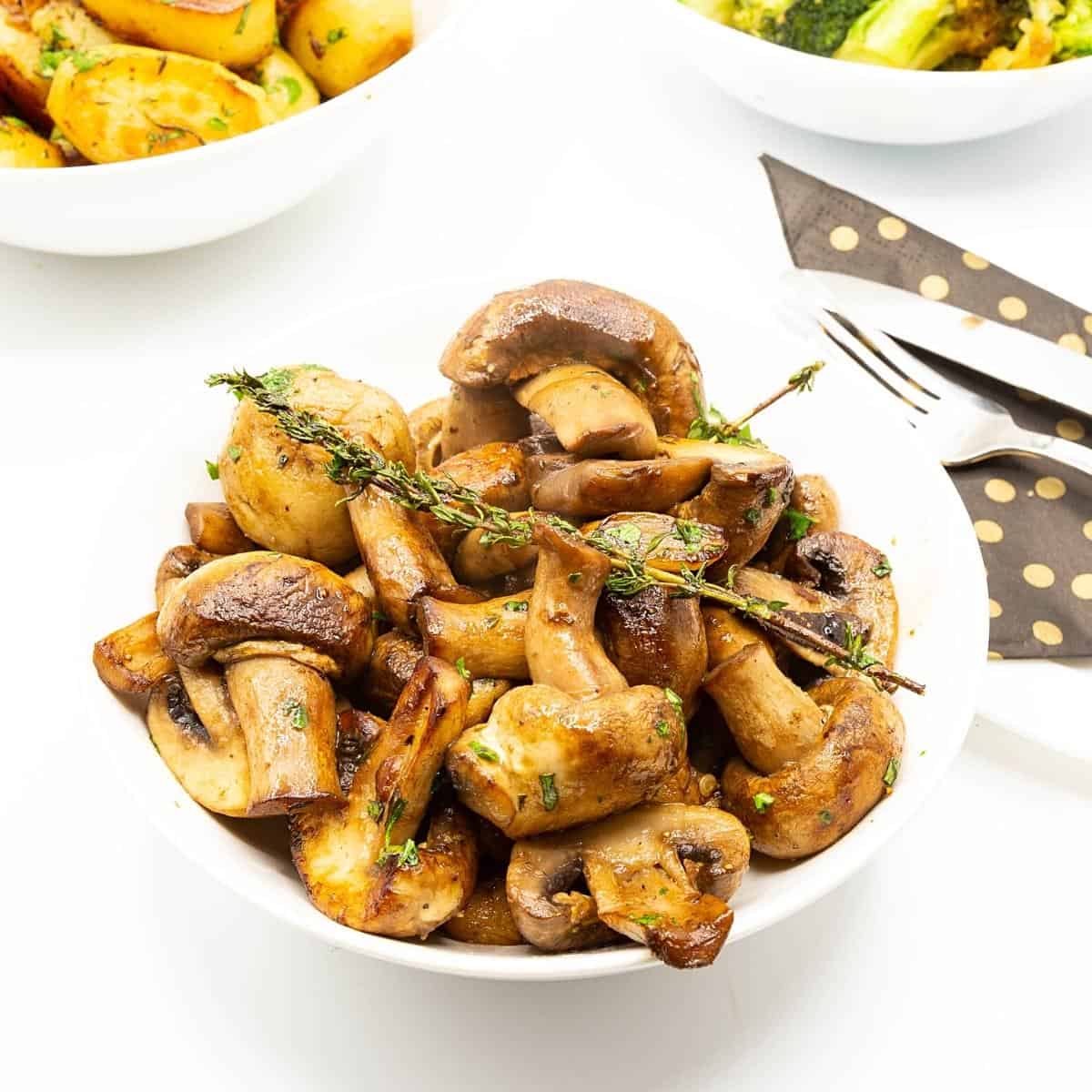 A bowl with sauteed mushrooms.