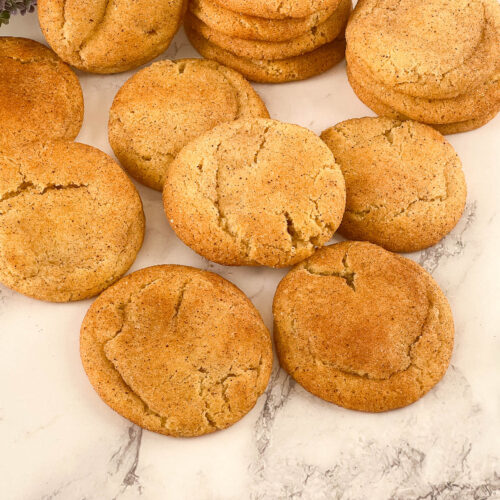 A spread of snickerdoodle cookies on a table.