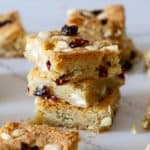 A stack of white chocolate cranberry bars on a table.
