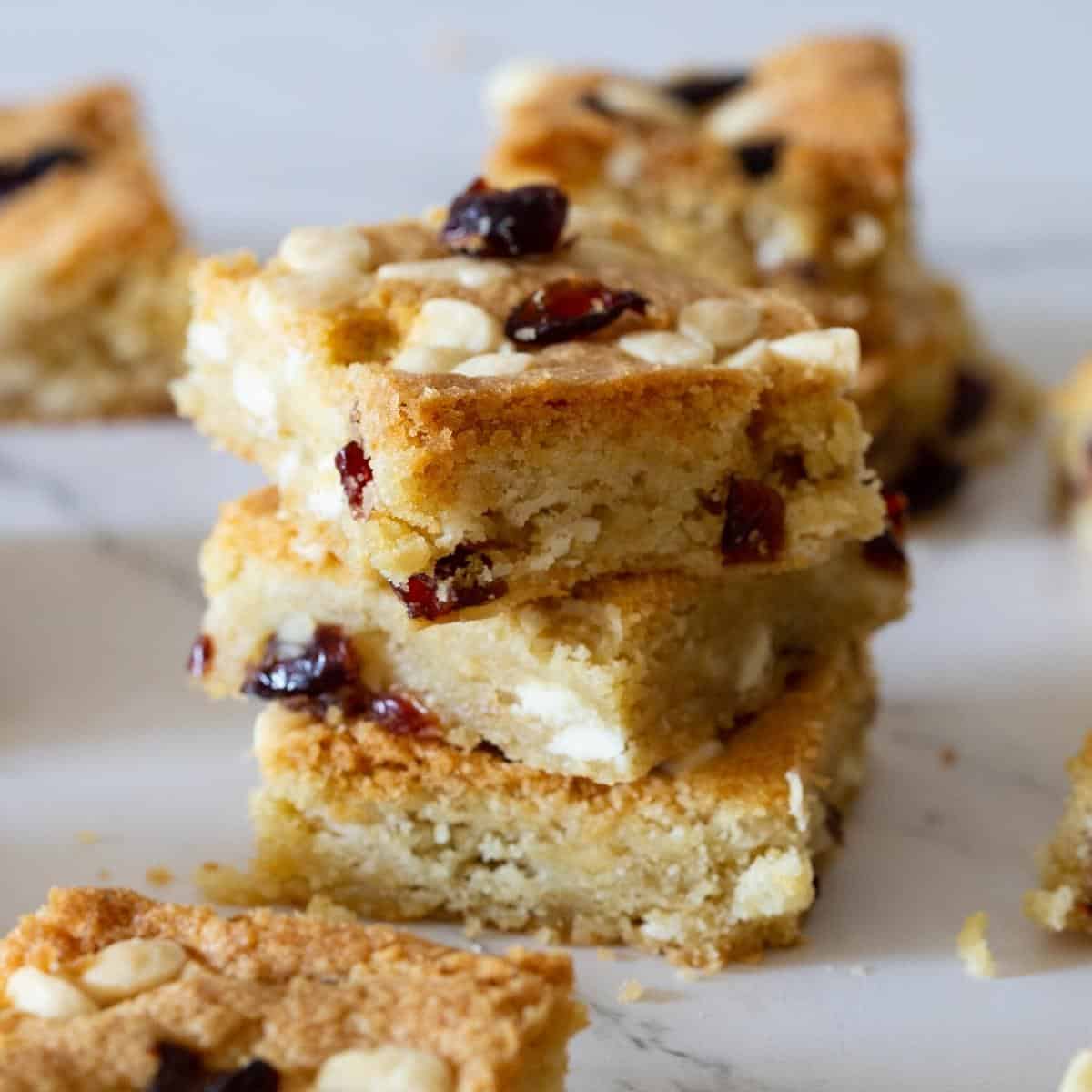 A stack of white chocolate cranberry bars on a table. 