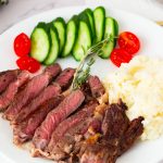 Med Rare Steak on the white plate with mashed potatoes.