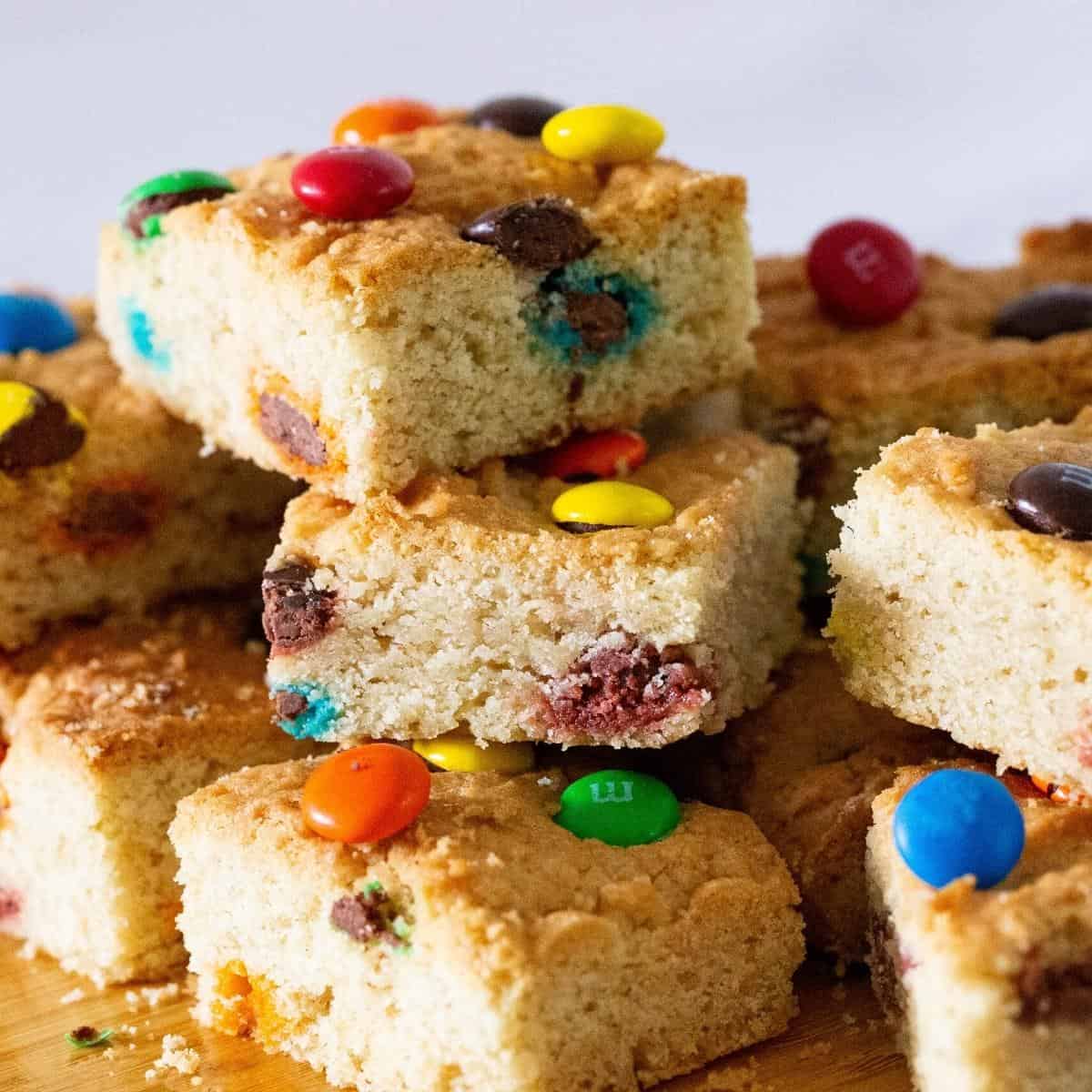 Stack of M&M cookie bars on a table.