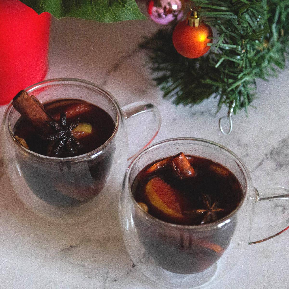 Two glasses with mulled wine in a Christmas setting.