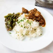 A plate with basmati rice and curry.