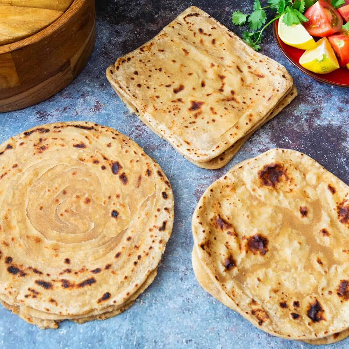Indian flatbreads on a wooden board.