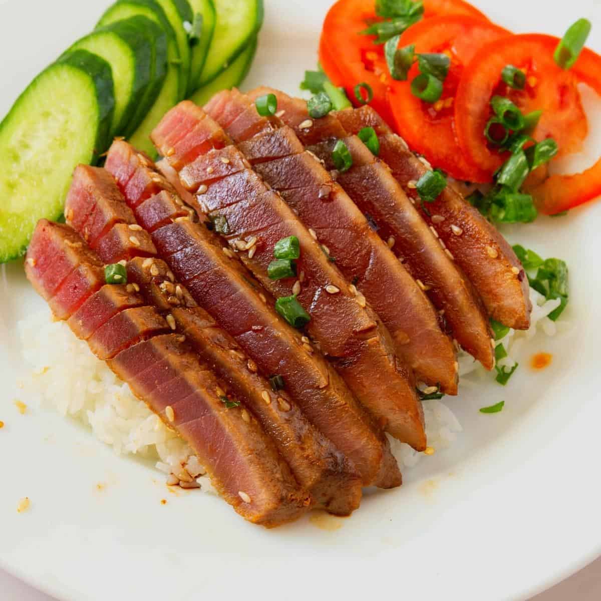 Tuna steak served on white steamed rice.