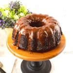 A chocolate cake with chocolate glaze on the cake stand