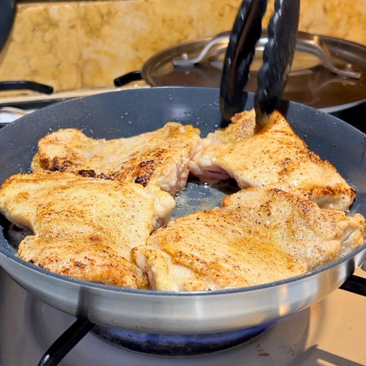 Progressing pictures searing boneless chicken thighs.