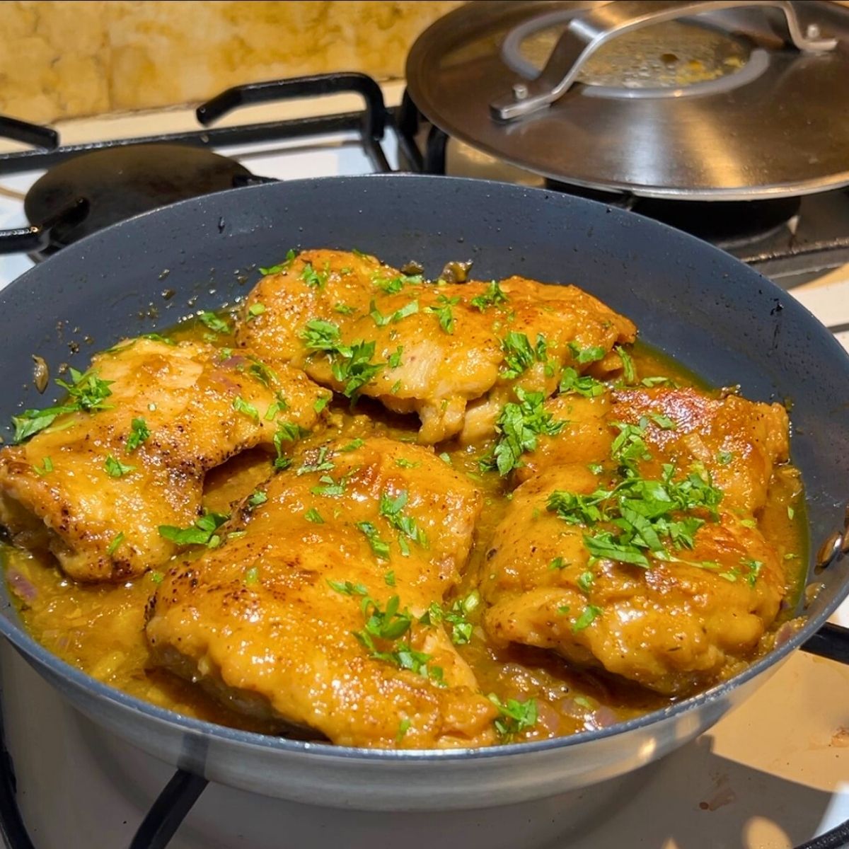 Pan seared Chicken in a skillet.