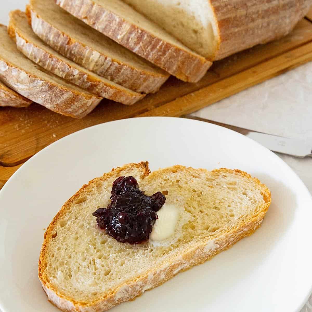 A slice of sourdough on the plate with jam.