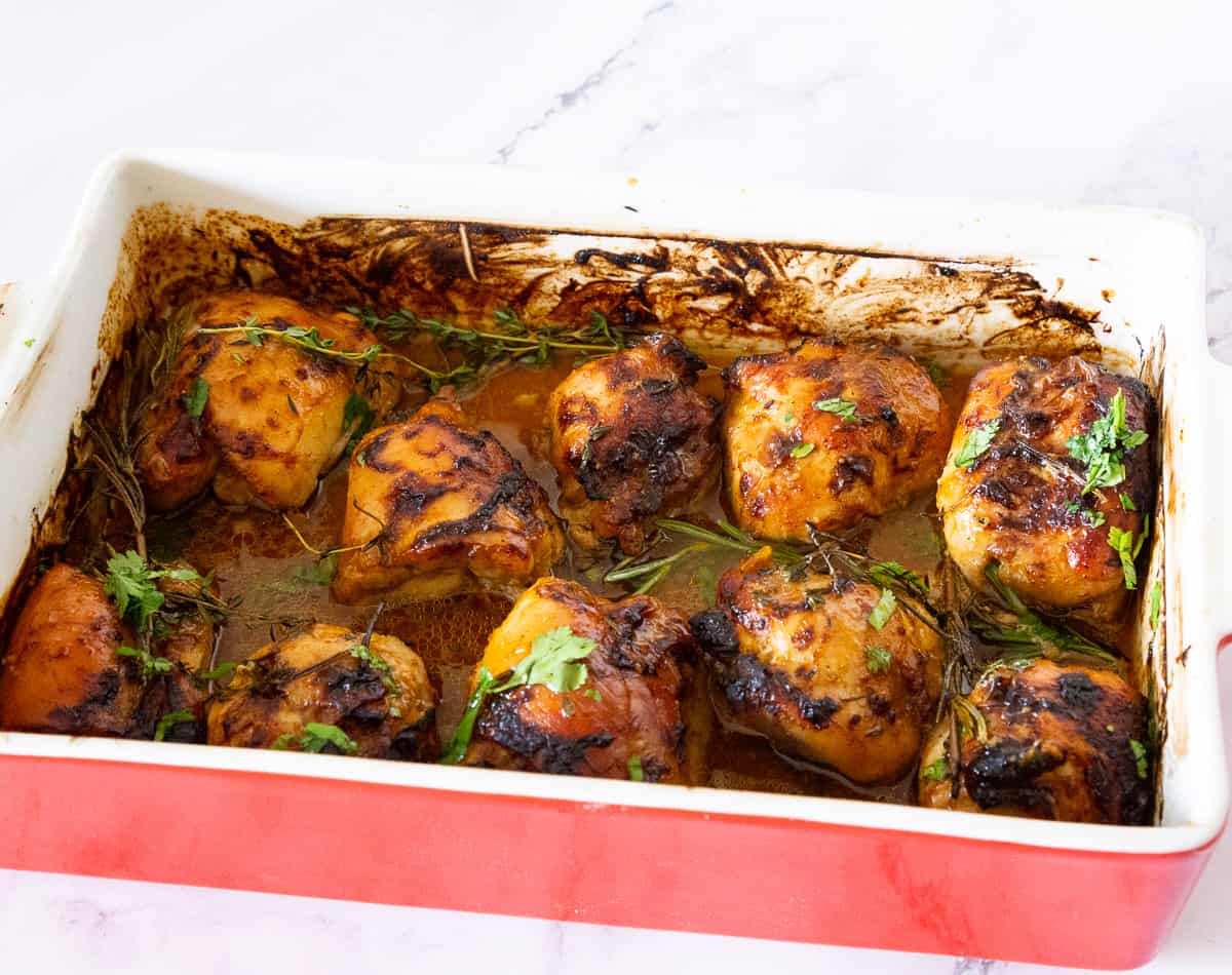A baking dish with baked chicken.