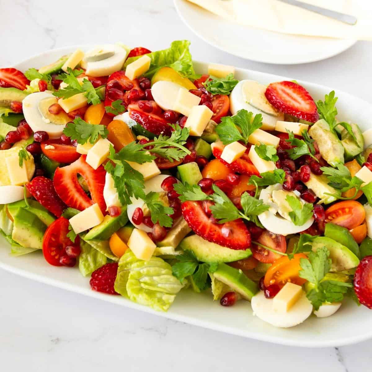 A large platter with garden veggies salad.