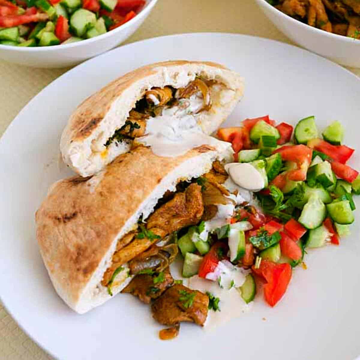 A pita bread with chicken shawarma.