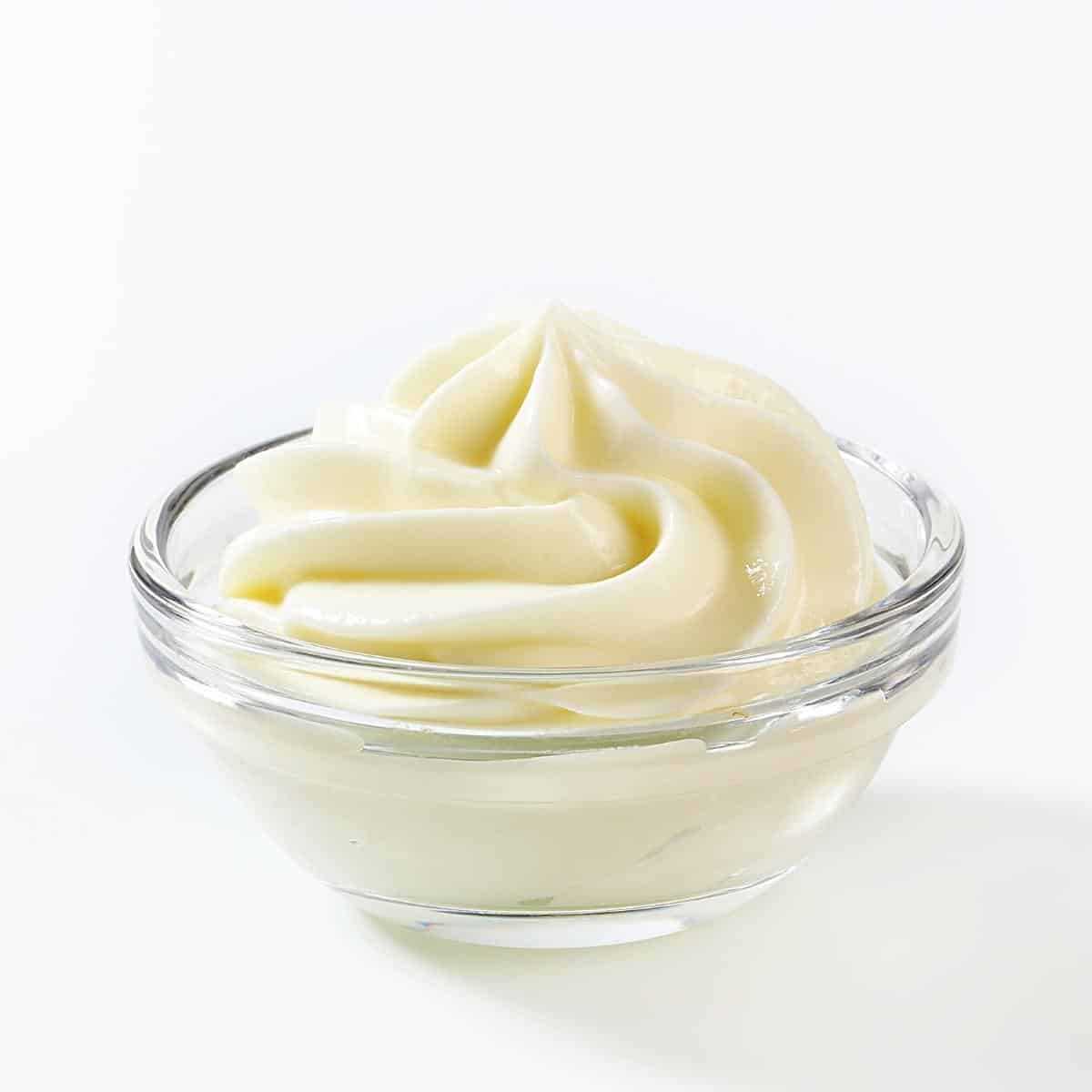A bowl with cream cheese frosting.