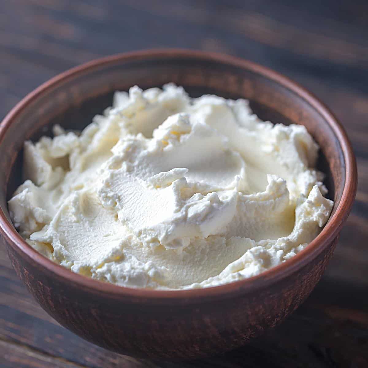 A bowl with cream cheese.
