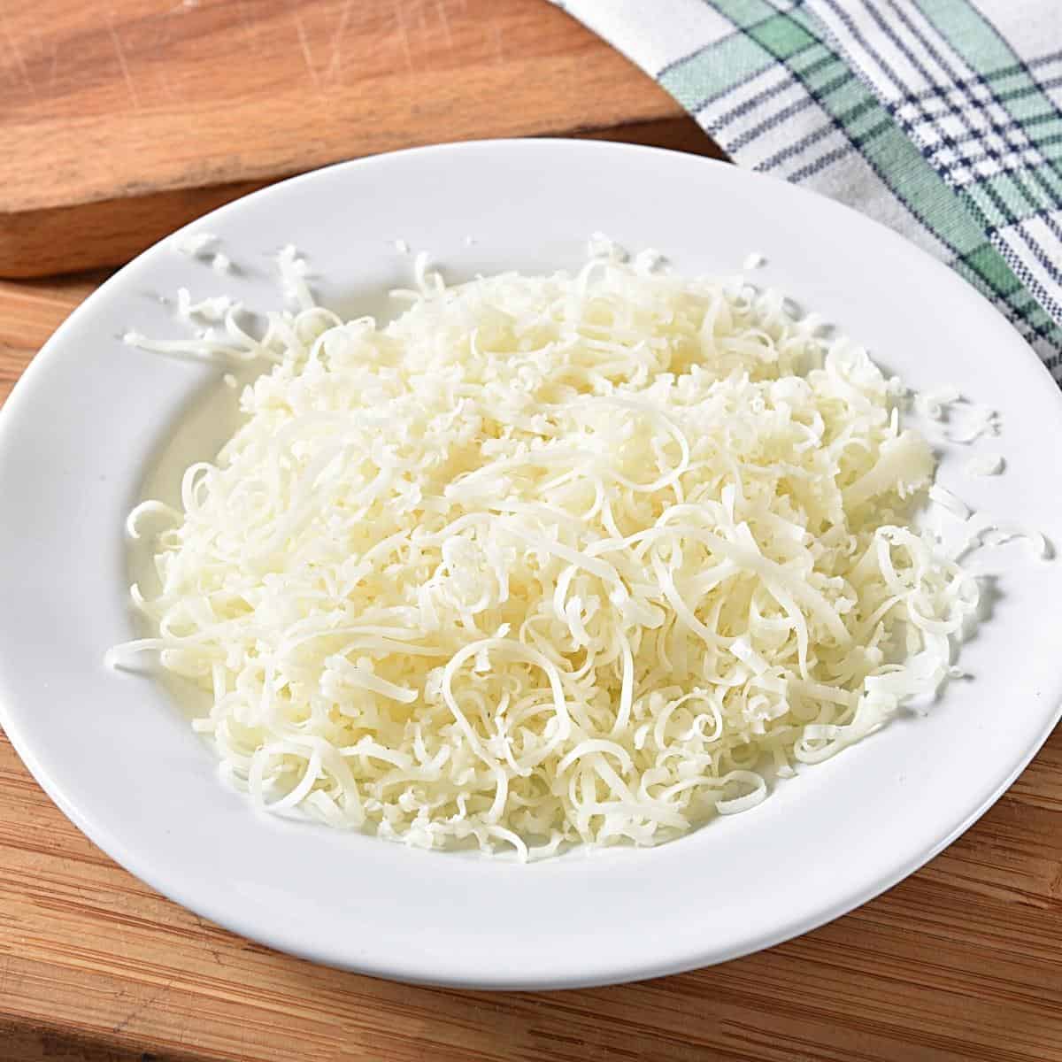 A bowl with shredded cheese.