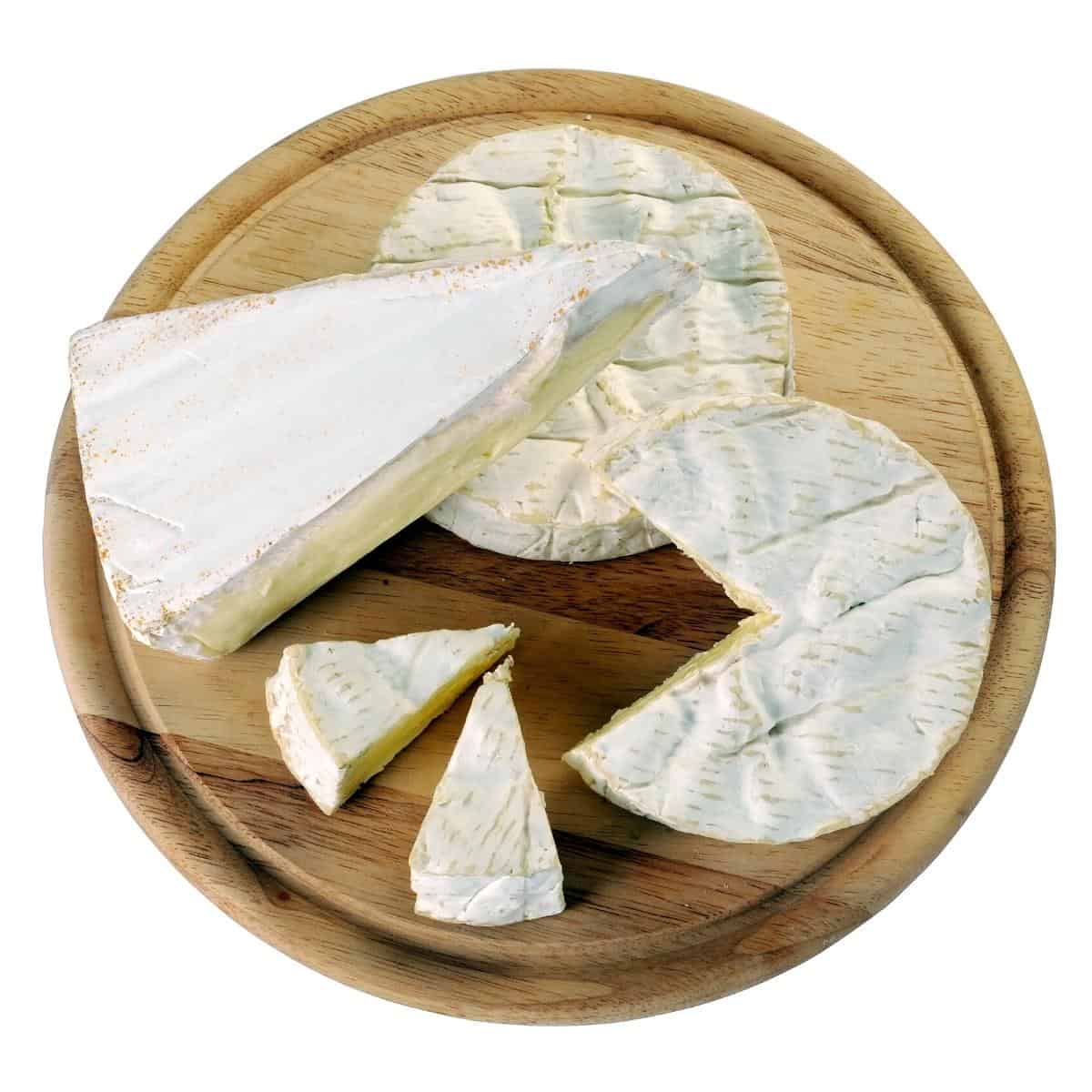 Camembert and brie on the cheeseboard.