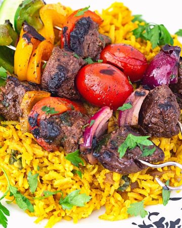 Three skewers on a bed of turmeric rice.