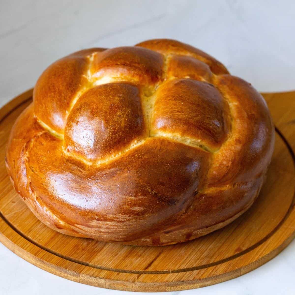 Round challah on a wooden board.