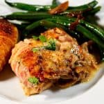 A plate with with chicken beans and potatoes.