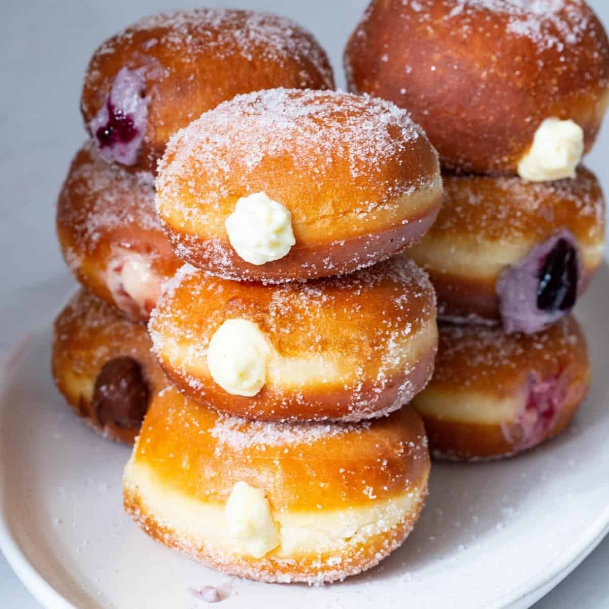 A stack of donuts with cream cheese.